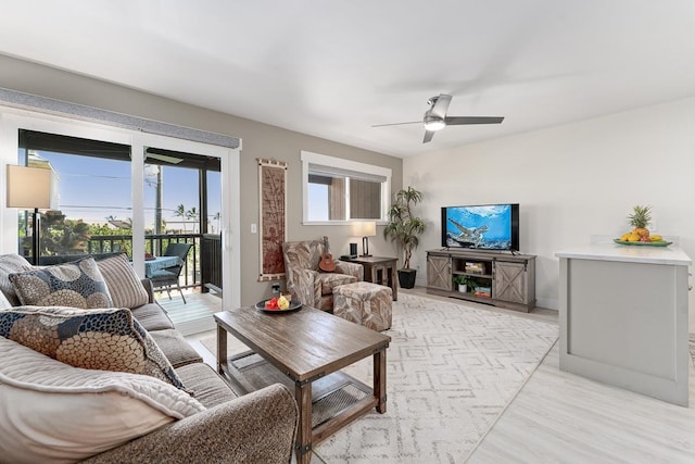 living area with ceiling fan and light wood-type flooring