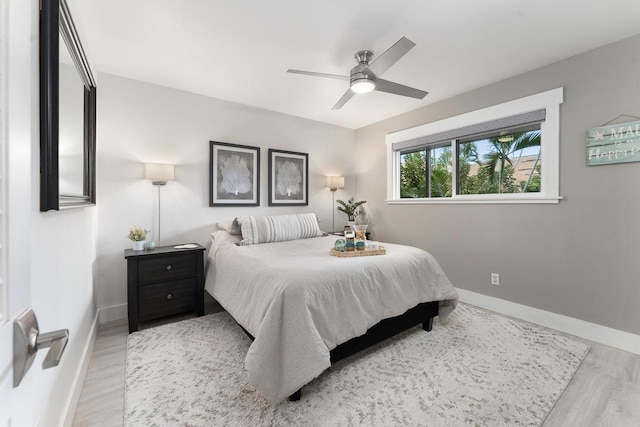 bedroom with baseboards, wood finished floors, and ceiling fan