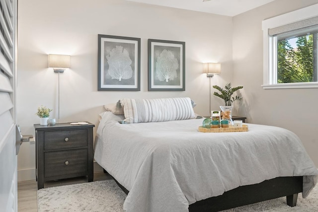 bedroom featuring wood finished floors and baseboards