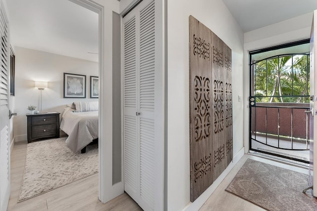 interior space with baseboards, wood finished floors, and a closet