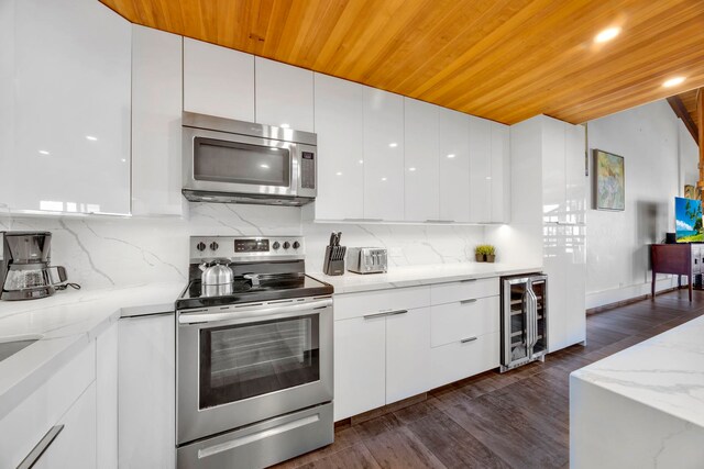 kitchen with white cabinetry, wood ceiling, stainless steel appliances, wine cooler, and light stone counters