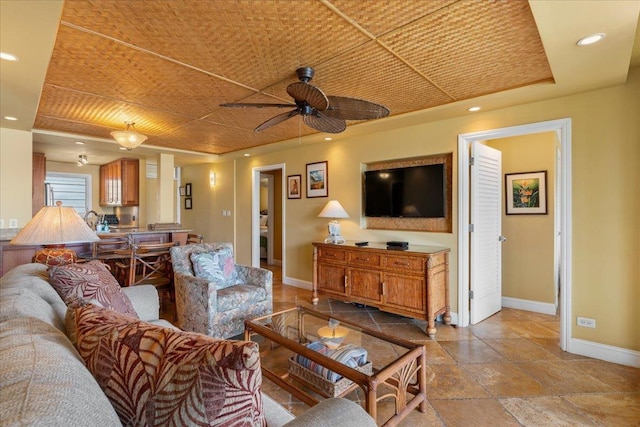 living room with ceiling fan and wood ceiling