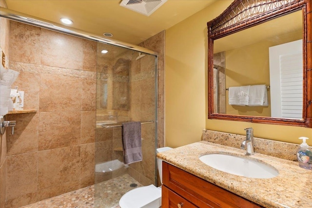 bathroom with vanity, toilet, and walk in shower