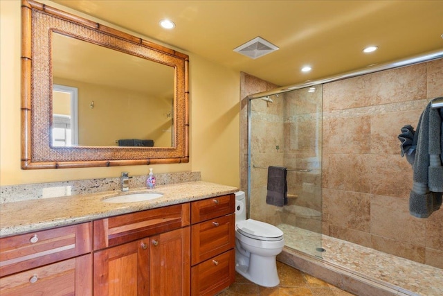 bathroom with tile patterned flooring, vanity, toilet, and a shower with shower door