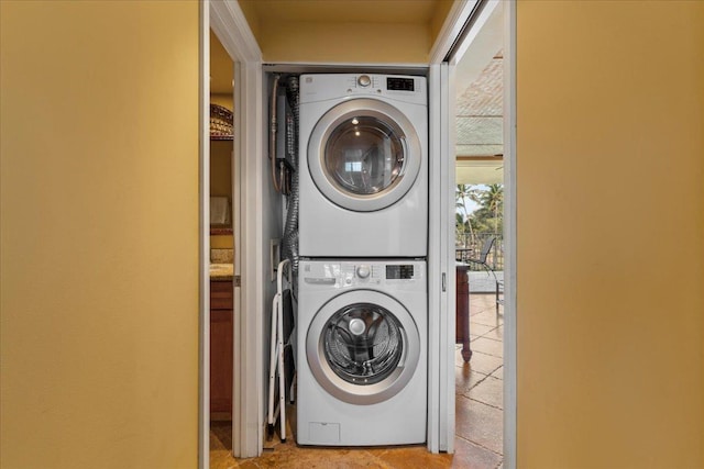 laundry area featuring stacked washer and clothes dryer