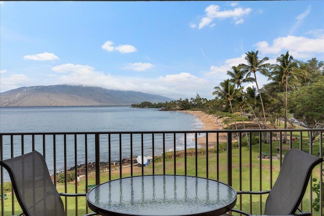 balcony featuring a water and mountain view