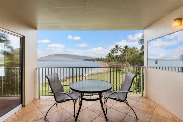 balcony with a water and mountain view