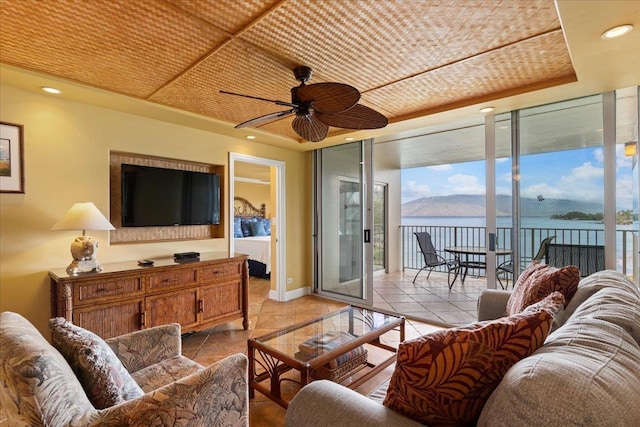 tiled living room featuring ceiling fan and wood ceiling