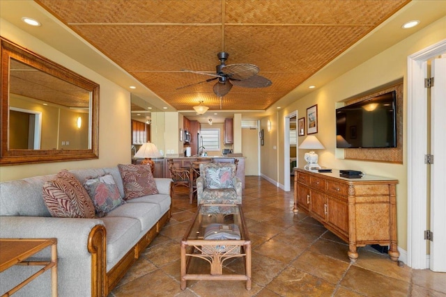 living room with ceiling fan, sink, and wood ceiling