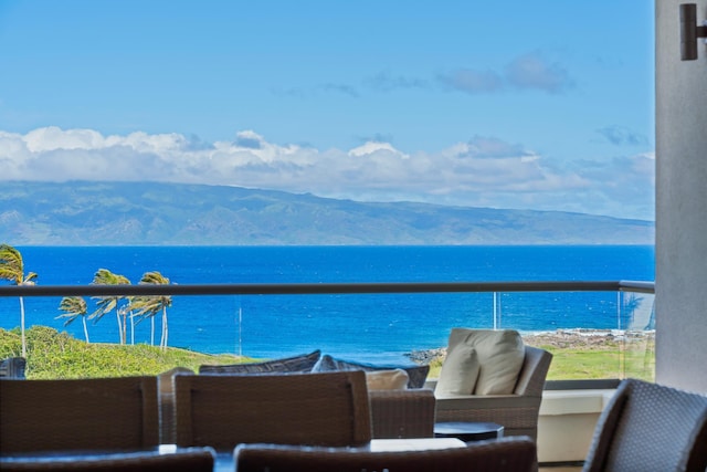 balcony featuring a water and mountain view