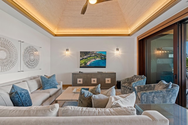 interior space featuring ceiling fan and a raised ceiling