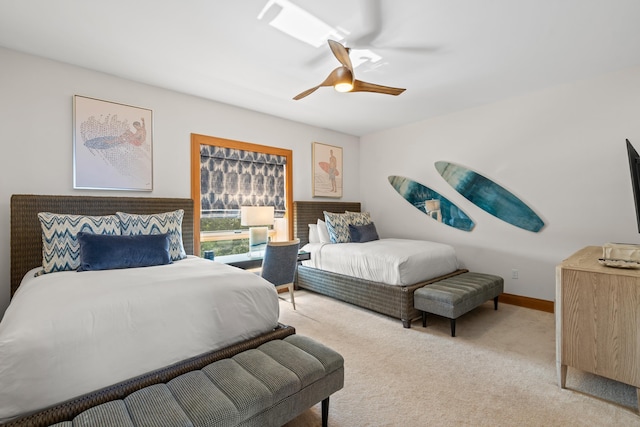 bedroom with a ceiling fan, light carpet, and baseboards