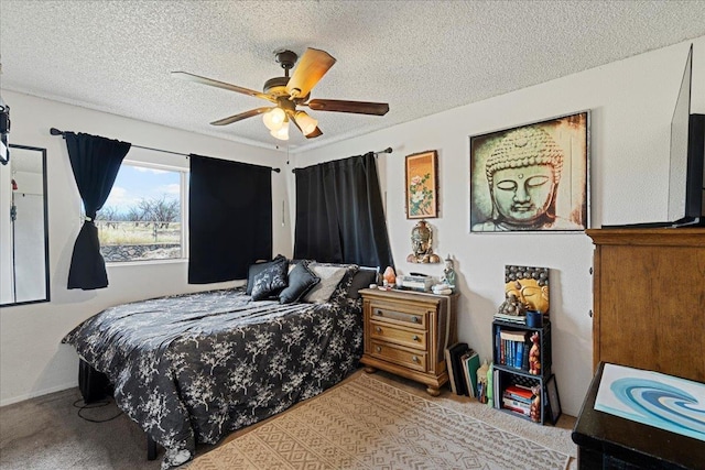 carpeted bedroom featuring a textured ceiling and a ceiling fan