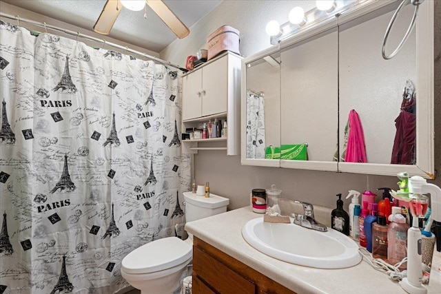 full bathroom with toilet, curtained shower, ceiling fan, and vanity