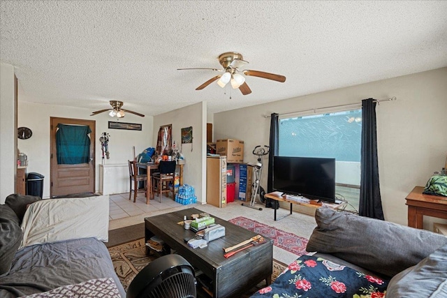 carpeted living room with ceiling fan and a textured ceiling