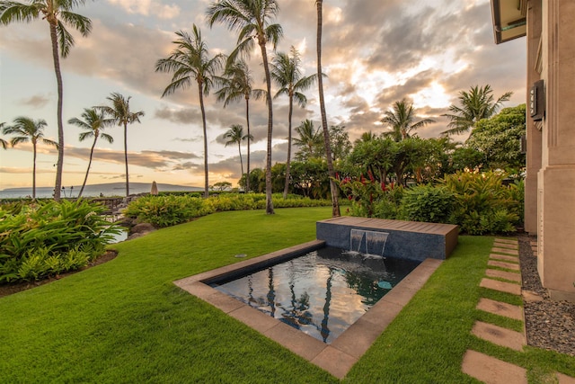 3800 Wailea Alanui Dr Unit B-102, Kihei, HI 96753 - pool at dusk featuring a lawn and an outdoor pool