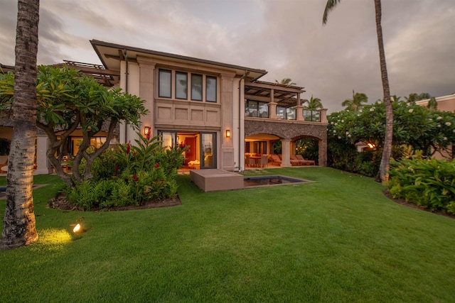 3800 Wailea Alanui Dr Unit B-102, Kihei, HI 96753 - back of house featuring a balcony, a yard, and stucco siding