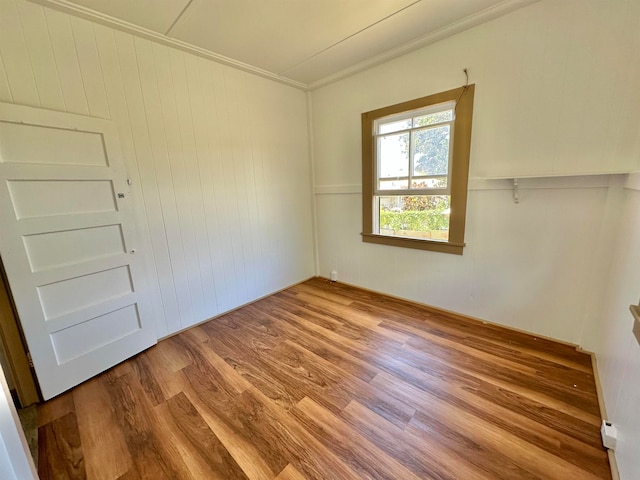 unfurnished room featuring light hardwood / wood-style floors and ornamental molding