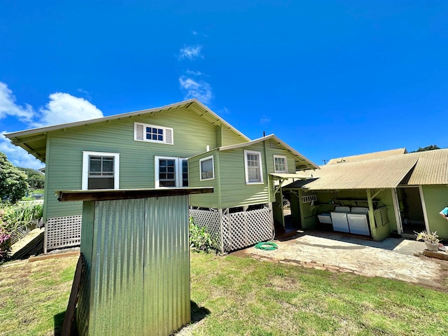 back of property with a carport