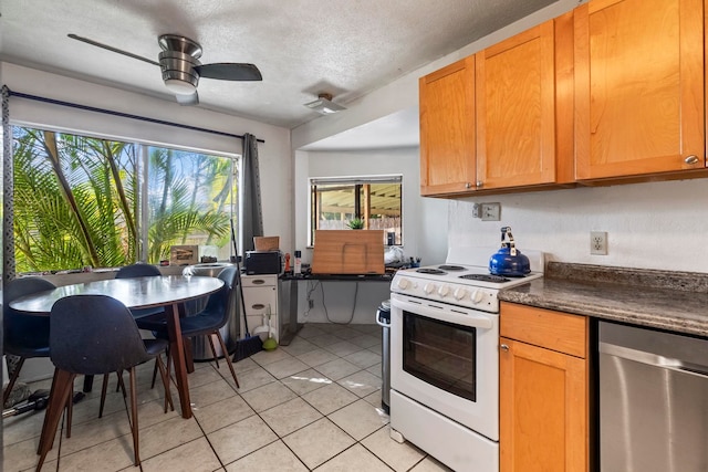 kitchen featuring stainless steel dishwasher, a textured ceiling, white range, ceiling fan, and light tile patterned flooring