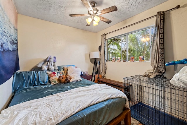 bedroom with ceiling fan and a textured ceiling