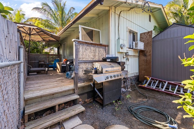 wooden deck with cooling unit and a storage shed