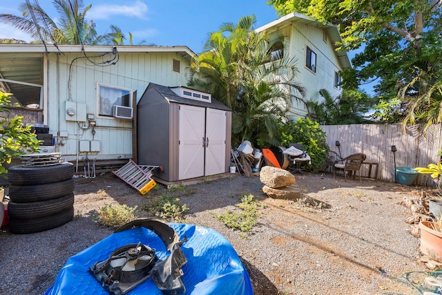 rear view of property featuring a shed