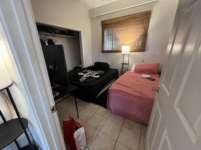 bedroom featuring a closet and light tile patterned floors