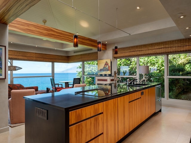 kitchen with a wealth of natural light, sink, and a water view