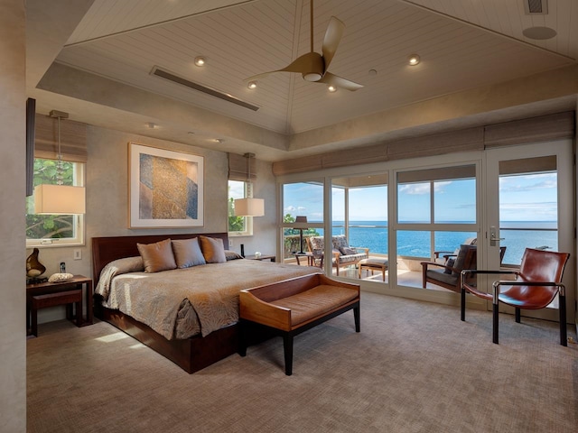 bedroom featuring ceiling fan, a water view, wood ceiling, and access to outside