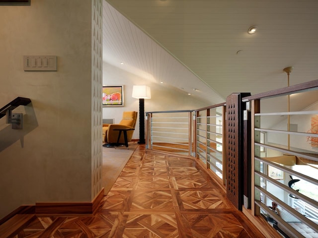 hallway featuring light parquet floors and high vaulted ceiling