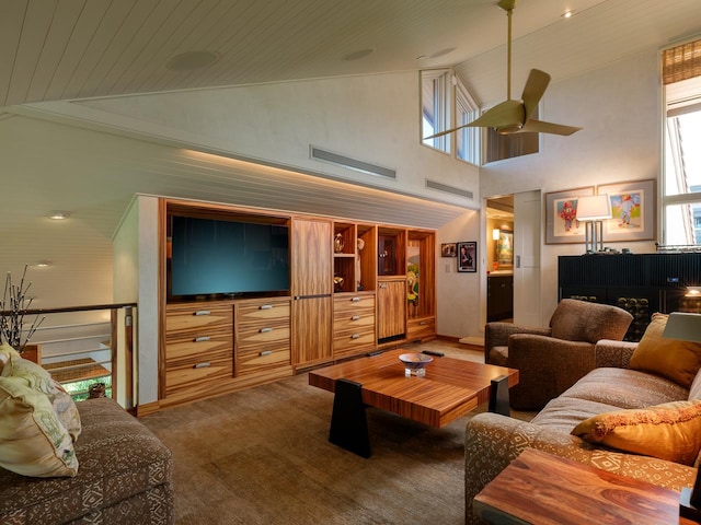 carpeted living room featuring ceiling fan and high vaulted ceiling