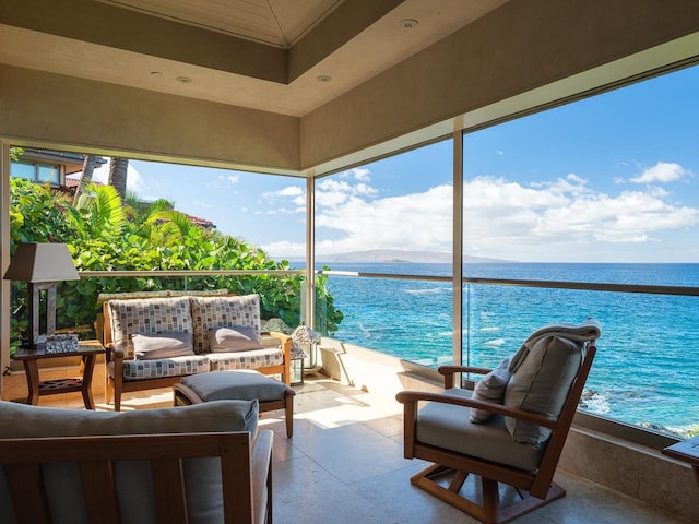 sunroom / solarium featuring a water view