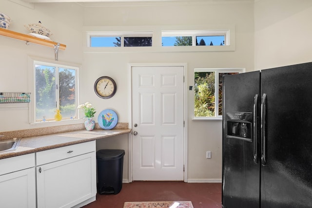 140 Kahana Ridge Dr, Lahaina, HI 96761 - kitchen featuring black refrigerator with ice dispenser, white cabinetry, light countertops, and dark carpet