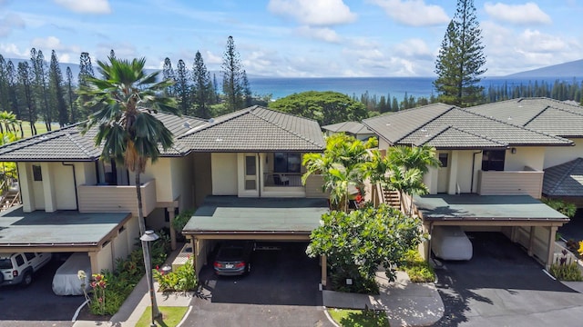 view of front of home featuring a water view and a carport