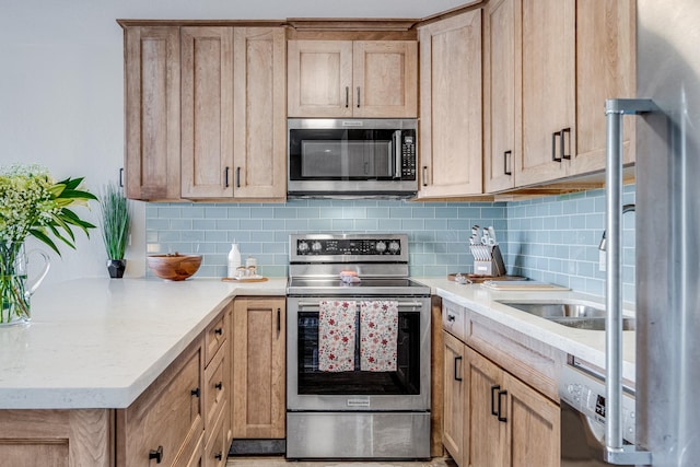 kitchen featuring appliances with stainless steel finishes, light brown cabinets, and decorative backsplash