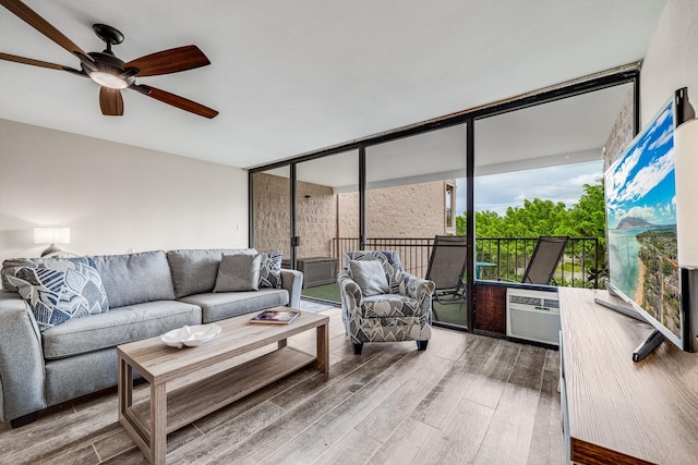 living room with ceiling fan, wood-type flooring, and expansive windows