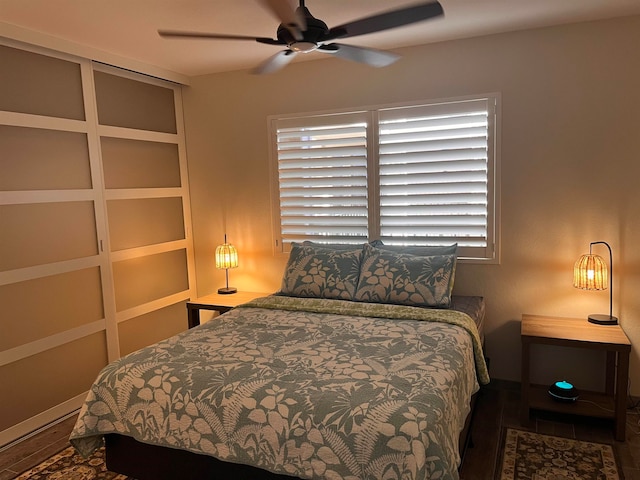 bedroom with ceiling fan and dark hardwood / wood-style flooring