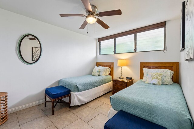 2653 S Kihei Rd Unit 306, Kihei, HI 96753 - bedroom featuring light tile patterned floors, a ceiling fan, and baseboards