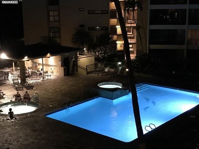 view of swimming pool featuring a hot tub and a patio