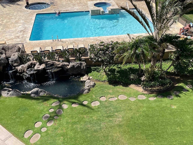 view of pool featuring a community hot tub, a lawn, and a patio