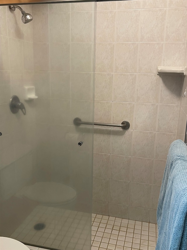 bathroom with tiled shower and toilet