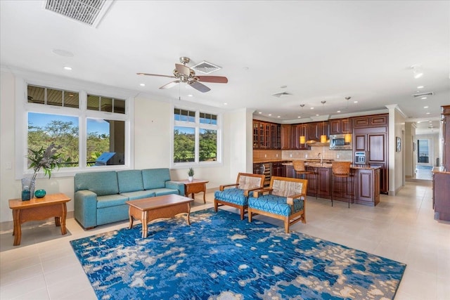 living room with a wealth of natural light, light tile patterned floors, and ceiling fan