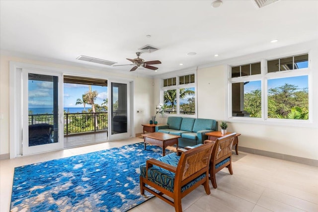 tiled living room featuring ceiling fan and plenty of natural light