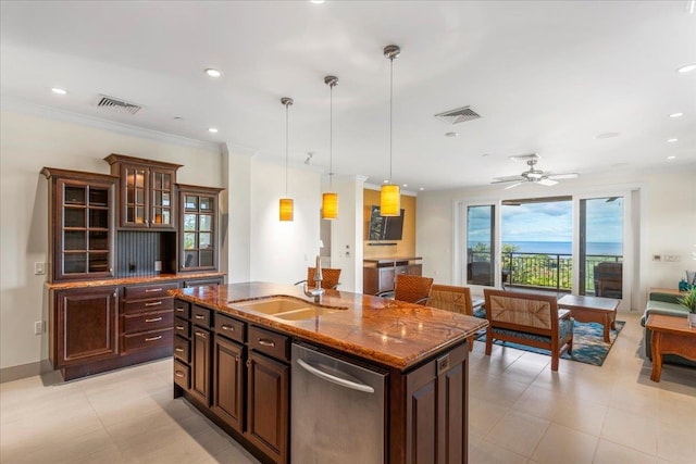 kitchen featuring a center island with sink, dishwasher, sink, pendant lighting, and dark stone countertops