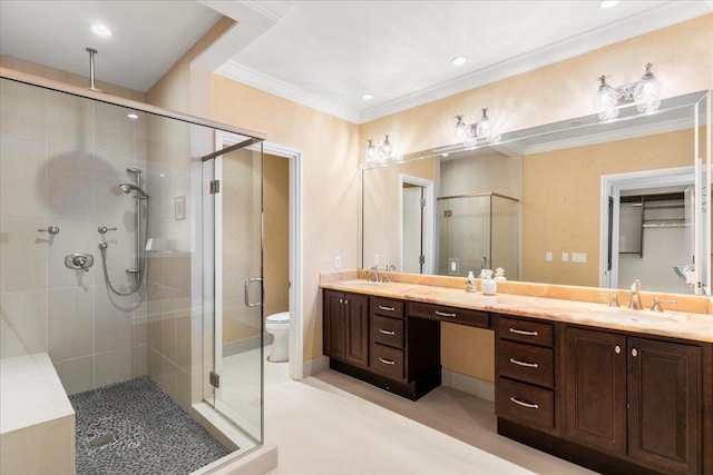 bathroom featuring ornamental molding, vanity, toilet, and a shower with door