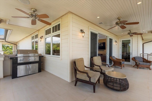 view of patio with area for grilling and ceiling fan