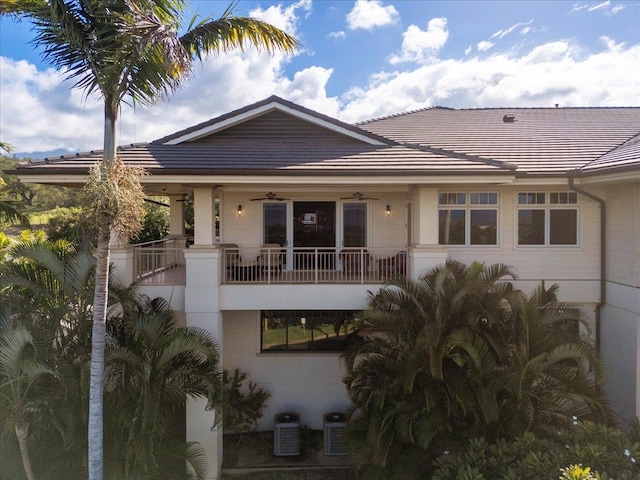 view of front of home featuring a tile roof, central AC unit, and ceiling fan