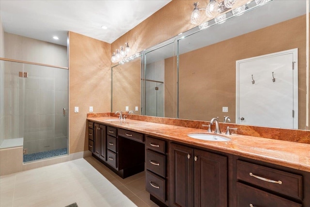 bathroom featuring vanity, a shower with shower door, and tile patterned flooring