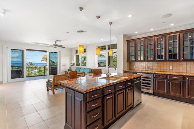 161 Wailea Ike Pl Unit C204, Kihei, HI 96753 - kitchen with beverage cooler, a sink, decorative backsplash, a kitchen island with sink, and hanging light fixtures